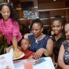Rudolph Brown/Photographer
Marie Allen, (left) serves the mothers with children from right Denesha Cawley with baby Kaylie Jones, Jheanelle Atkinson, Yasheca Osbourne and Antwan Osbourne at Rituals Cafe Mother's Day Brunch at Mall Plaza in Kingston on Sunday, May 11, 2014