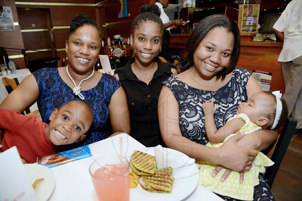 Rudolph Brown/Photographer
Enjoying a casual brunch and a day out on the town are (from left) Antwan Osbourne, Yasheca Osbourne, Jheanelle Atkinson and Denesha Cawley with baby Kaylie Jones at Hamilton's Smoked House and Rituals Cafe Mother's Day Brunch at Mall Plaza on Sunday.