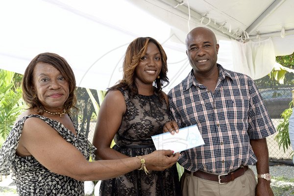 Gladstone Taylor / Photographer

Ellen Stennet (Supervisor, The oasis on the oxford) hands over the gate prize of a trip to dolphin cove to  Natalee Stewart and Evol Wilson as seen at the mothers day brunch at the oasis on the oxford