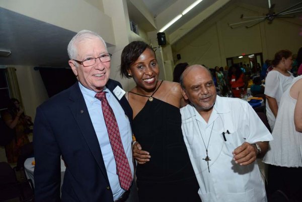 Rudolph Brown/PhotographerRev. Msgr. Gregory Ramissoon, (right) Founder of Mustard Seed pose with Cy Yanarelli, (left) and Donna Reynolds at the Mustard Seed communities 40th anniversary awards and banquet at the St. Peter and Paul Church Hall on Saturday, September 8, 2018