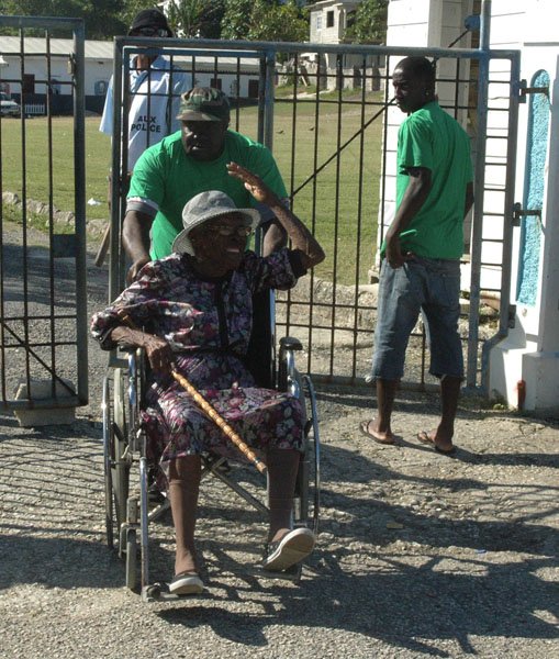 Adrian Frater/Reporter
Election Day
This elderly voter, being assisted by a Jamaica Labour Party (JLP) activist, was seemingly quite joyful after casting her vote in Eastern Hanover yesterday.