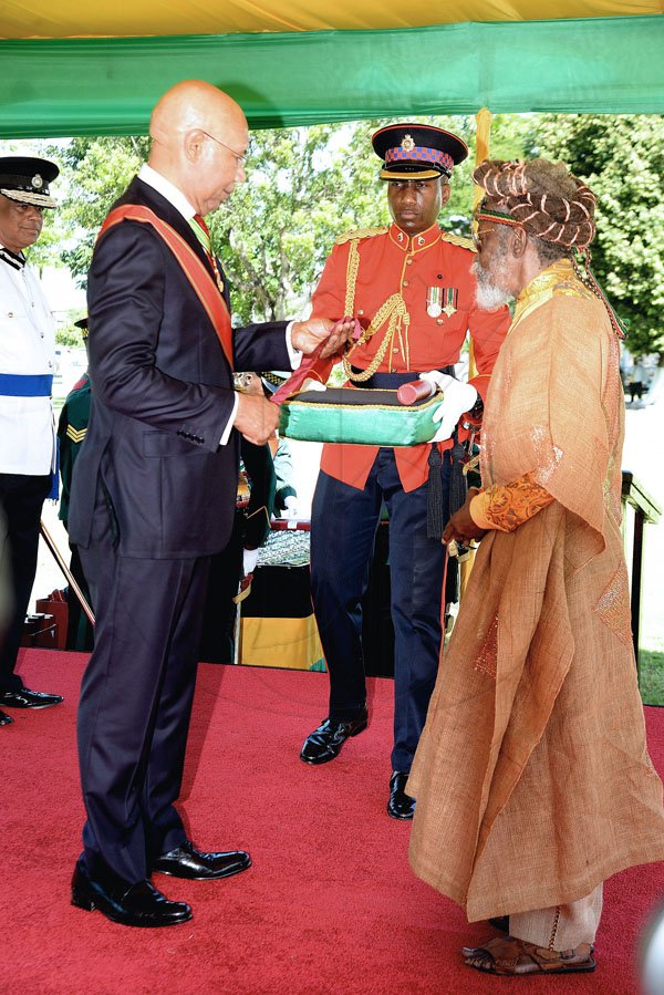 Lionel Rookwood/PhotographerThe Honourable Neville O'Reilly "Bunny Wailer" Livingstone,OJ,CD recieves The Order of Jamaica from Governor General Sir Patrick Allen at the National Awards held at King's House on Monday October 16,2017. *** Local Caption *** Lionel Rookwood/Photographer Neville O'Reilly "Bunny Wailer" Livingstone,OJ, CD, the only living member of the super popular Bob Marley and the Wailers group was appointed as a member of the Order of Merit, the fourth highest national honour, yesterday for outstanding contribution in the field of popular music.
