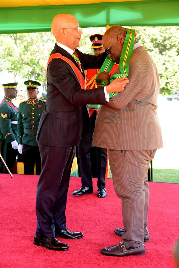 Lionel Rookwood/PhotographerVincent Stephen Francis,OD recieves The Order Of Jamaica from Governor General Sir Patrick Allen at The National Awards held at King's House on Monday October 16,2017.