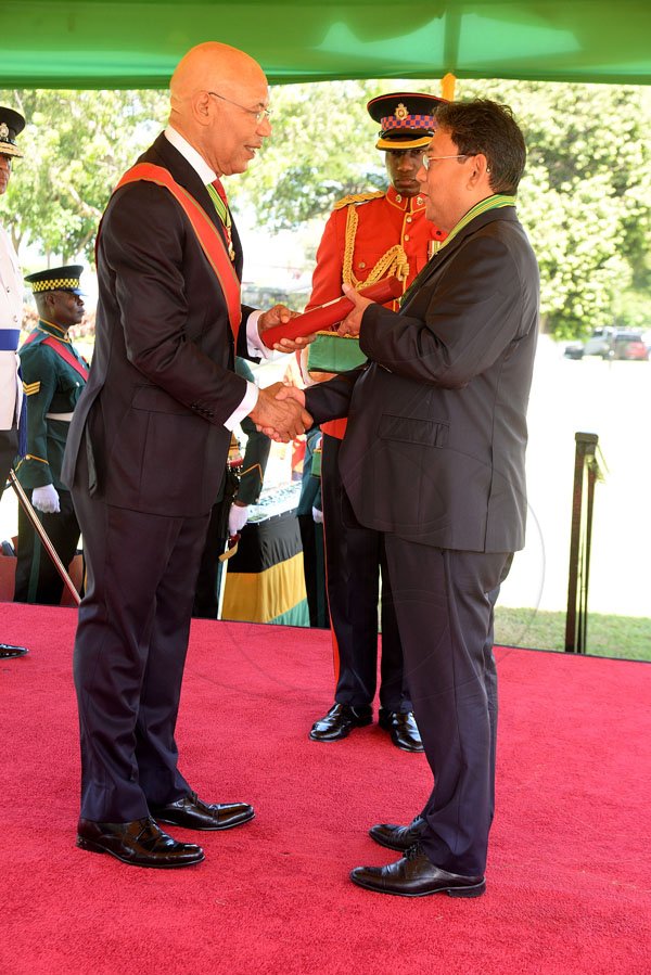 Lionel Rookwood/PhotographerPaul Anthony Hoo recieves The Order Of Distinction in the rank of Commander for oustanding contribution to the Sporting Industry in Jamaica from Governor General Sir Patrick Allen at The National Honours and Awards Ceremony held at King's House on Monday October16th,2017.