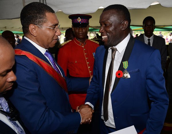 Lionel Rookwood/PhotographerTheodore Eccleston "Tappa" Whitmore greets Prime Minister Andrew Holness after  The National Honours and Awards Ceremony held at King's House on Monday October16th,2017.