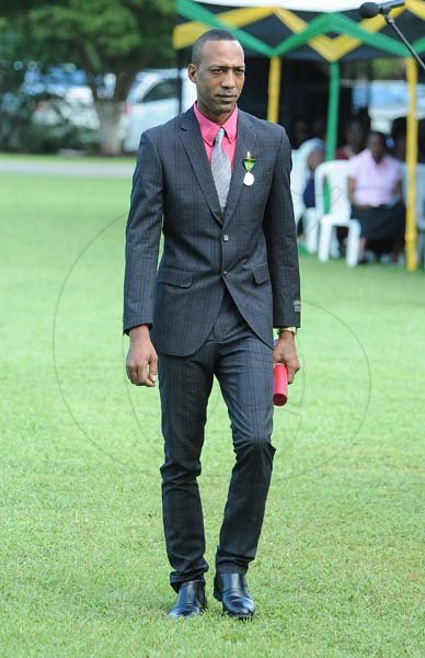 Lionel Rookwood/PhotographerKimani Anderson walks back after being presented the Badge of Honour for Gallantry at the Presentation of National Honours and Awards held at King's House on October 15th,2018.