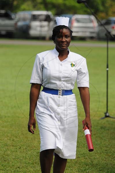 Lionel Rookwood/PhotographerCamille McIntosh walks back after being presented the Badge of Honour for Gallantry at the Presentation of National Honours and Awards held at King's House on October 15th,2018.