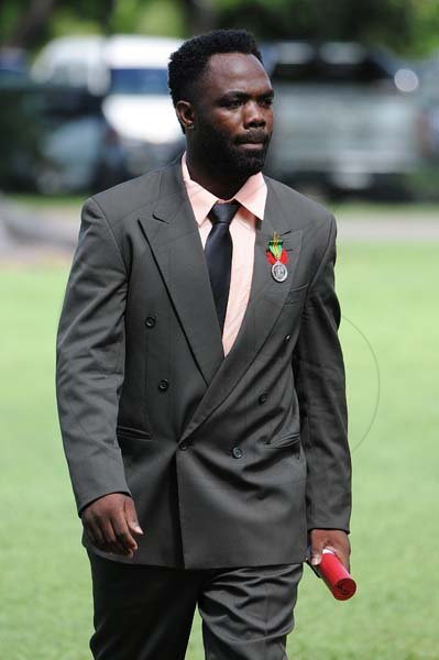 Lionel Rookwood/PhotographerAristel St.Joy walks back after being presented the Badge of Honour for Gallantry at the Presentation of National Honours and Awards held at King's House on October 15th,2018.