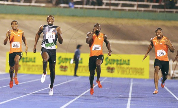 Ricardo Makyn/Staff Photographer
Yohan Blake (right) battles with (from left) Warren Weir, Usain Bolt and Nickel Ashmeade on the way to winning the men's 200 metres final at the JAAA/Supreme Ventures National Senior Track and Field Athletics Championships at the National Stadium on Sunday night.