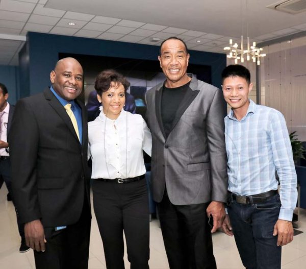Ashley Anguin<\n>From left: Wayne Hunter, manager NCB Fairview Branch with Karis Bailey, Yardie Auto Sales; Michael Lee-Chin, chairman NCB Financial Group, and Li Yangsen.