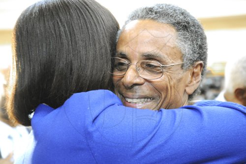 Ricardo Makyn/Staff Photographer
Member of Parliament Patrick Atkinson is receives an embrace from  Prime Minister Portia Simpson Miller  at the  swear-in Ceremony for  Ptraick Atkinson as Attorney General   at Kings House on Tuesday 10.1.2012