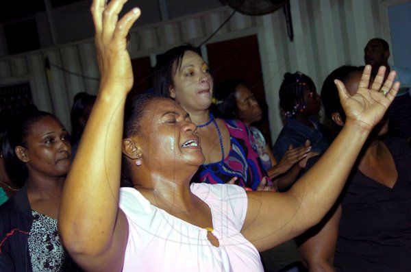 Norman Grindley/Chief Photographer
Worshippers who attended watchnight service at Agape Christian fellowship church in Gregory Park St Catherine, as they embraced in the new year.
