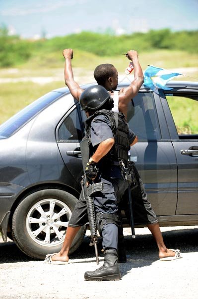 Ricardo Makyn/Staff Photographer
A policewoman frisks a motorist in the Newland neighbourhood of Portmore, St Catherine, yesterday. A curfew was imposed in sections of Portmore as the security forces widen their search for gunmen and illegal weapons.

Curfew in the New Lands community of Portmore on Monday 28.6.2010.