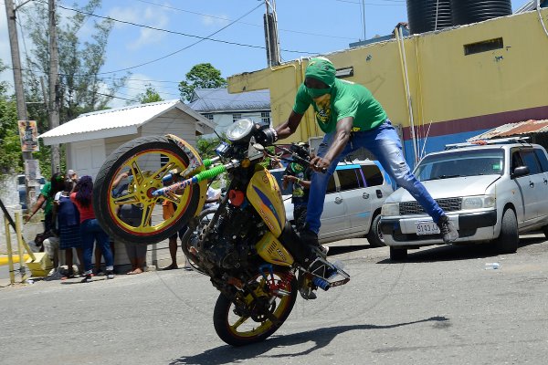 A JLP biker showed his skills during the gathering at Chapelton Family Court Park, Main Street Chapelton, on nomination day, August 18, 2020.