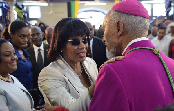 Rudolph Brown/Photographer
Prime Minister Portia Simpson Miller greets Rev. Donald Reece, President of the Jamaica Council of Churches at the service of thanksgiving for the 140th Anniversary of the City of Kingston and The Achievements of the London 2012 Olympians and Paralympians " Repairing the Breach, Restoring the Treasure" at the East Queen Street Baptist Church on East Queen Street in Kingston on Sunday, October 14, 2012
