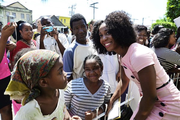 Rudolph Brown/Photographer
Shelly-Ann Fraser Pryce greeted by children at the service of thanksgiving for the 140th Anniversary of the City of Kingston and The Achievements of the London 2012 Olympians and Paralympians " Repairing the Breach, Restoring the Treasure" at the East Queen Street Baptist Church on East Queen Street in Kingston on Sunday, October 14, 2012