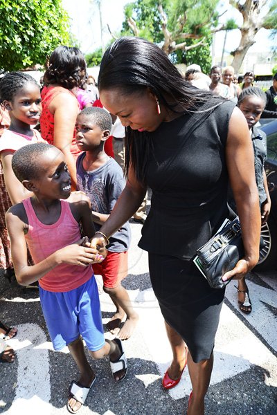 Rudolph Brown/Photographer
Veronica Campbell-Brown  being greeted by children at the service of thanksgiving for the 140th Anniversary of the City of Kingston and  the achievements of the London 2012 Olympians and Paralympians , at the East Queen Street  Baptist Church yesterday.