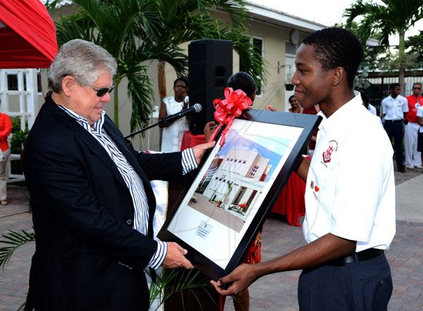 Winston Sill/Freelance Photographer
Dedication and Opening Ceremony of the Jonathan Stewart Library Media Centre, Campion College on Thursday evening October 24, 2013. Here Hon. Gordon "Butch" Stewart (left) is presentd with a photograph of the building by a student.
