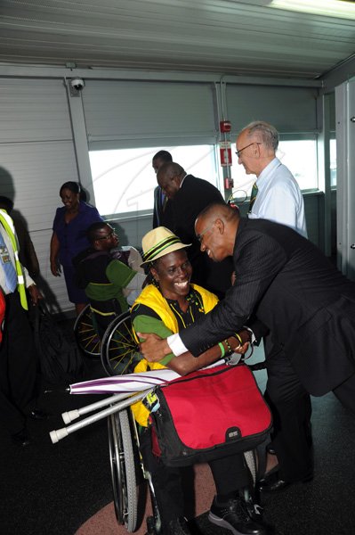 Norman Grindley/Chief Photographer
The Jamaica paralympic Association team arrives at the Norman international airport in Kingston yesterday.