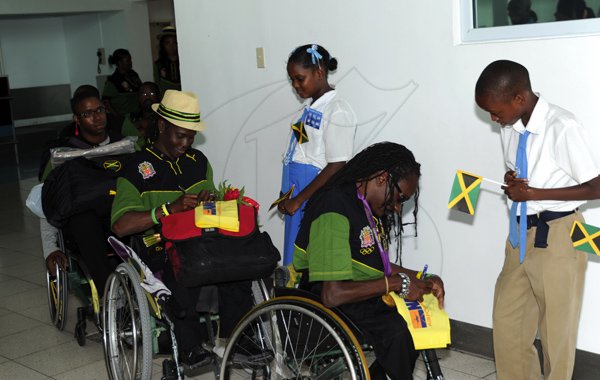 Norman Grindley/Chief Photographer
The Jamaica paralympic Association team arrives at the Norman international airport in Kingston yesterday.