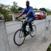 Ricardo Makyn/Staff Photographer 
A pedal cyclist rides on the Bridge adjacent to the Health centre in   Spanish Town