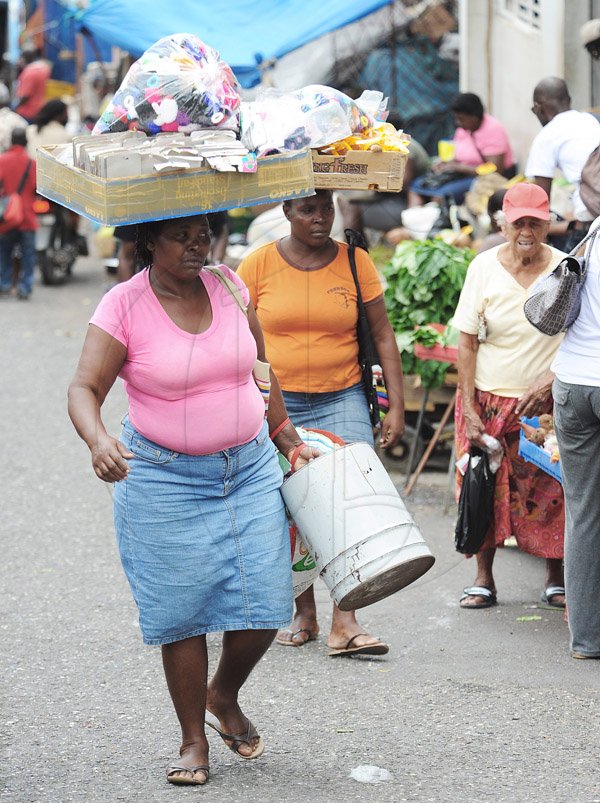 Jermaine Barnaby/Photographer
These two vendors were seen making their way to the St Ann's bay arcade during a tour of parish capital, St Ann's Bay on Saturday March 21, 2014.