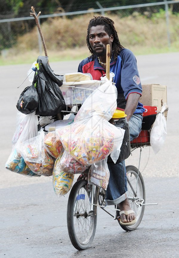 Jermaine Barnaby/Photographer
Snacks and juices can be purchased from this man who sells from his bicycle duirng a tour of parish capital, St Ann's Bay on Saturday March 21, 2014.