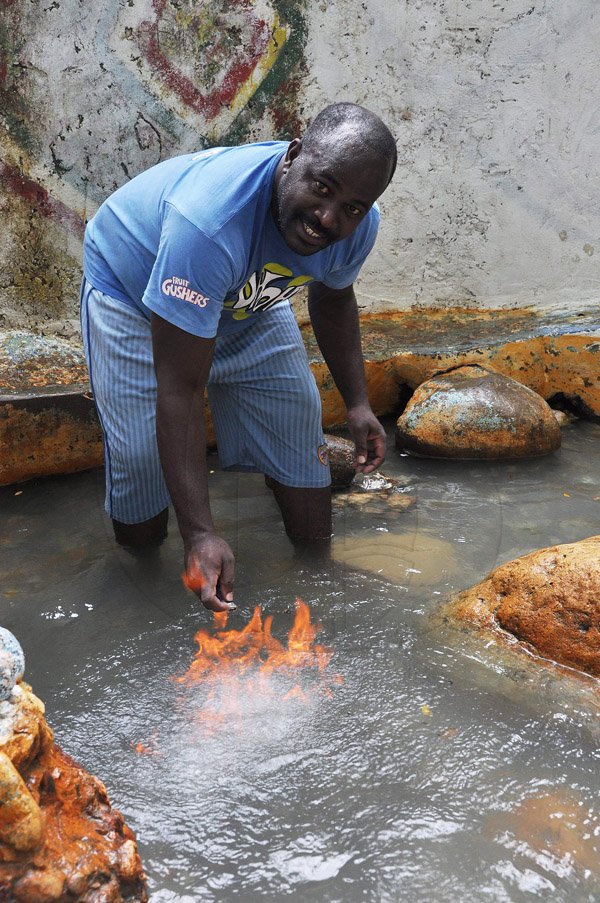 Jermaine Barnaby/Photographer
Kevin Chambers shows that fire can be lit on top of water in a mineral bath in Riverlane, a community in Windsor in St Ann's bay during a tour of parish capital, St Ann's Bay on Saturday March 21, 2014.