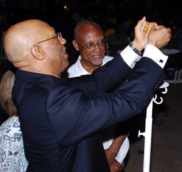 Colin Hamilton/freelance photographer
The GG Sir Patrick Allen tries a different method to light the candle while Professor Barry Chevannes looks on during the Peace Month Peace Vigil: Sounds and Stories hosted by The Violence Prevention Alliance at the Emancipation Park on Tuesday March 2, 2010.