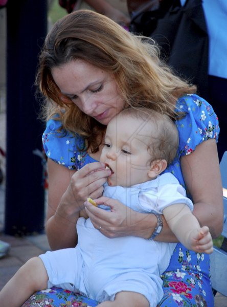 Colin Hamilton/freelance photographer
Geraldine O'Callahan feeds baby Sammy during the Peace Month Peace Vigil: Sounds and Stories hosted by The Violence Prevention Alliance at the Emancipation Park on Tuesday March 2, 2010.