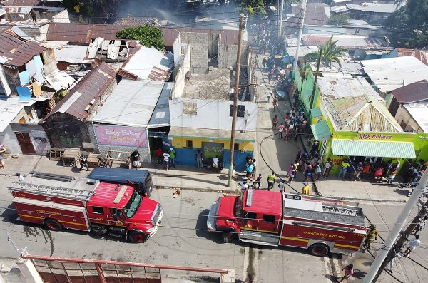 An aerial photograph of two fire trucks parked on Charles Street responding to a fire on Pink Lane on Tuesday May 26, 2020. The fire gutted five homes and damaged another three.