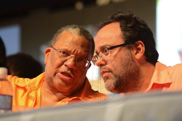 Rudolph Brown/Photographer
Finance Minister Dr Peter Phillips (left) has the attention of Justice Minister Mark Golding.

PNP's 74th Annual Conference 2012 at National Arena in Kingston on Sunday, September 16-2012