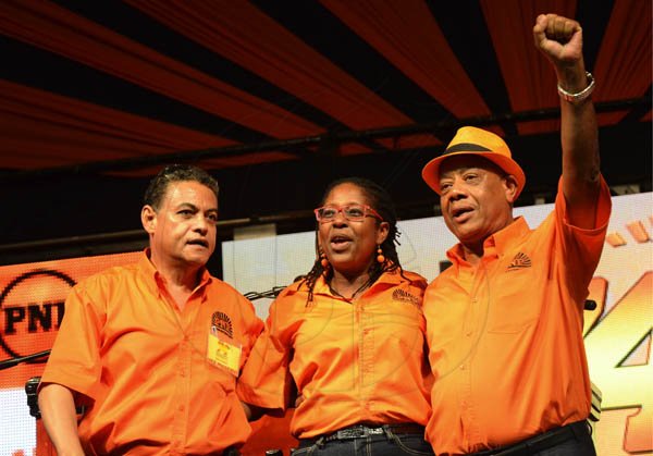 Rudolph Brown/Photographer
PNP Vice-Presidents (from left) Noel Arscott, Angela Brown Burke and Derrick Kellier salute the crowd at the PNP's 74th Annual Conference 2012 at National Arena in Kingston on Sunday, September 16-2012