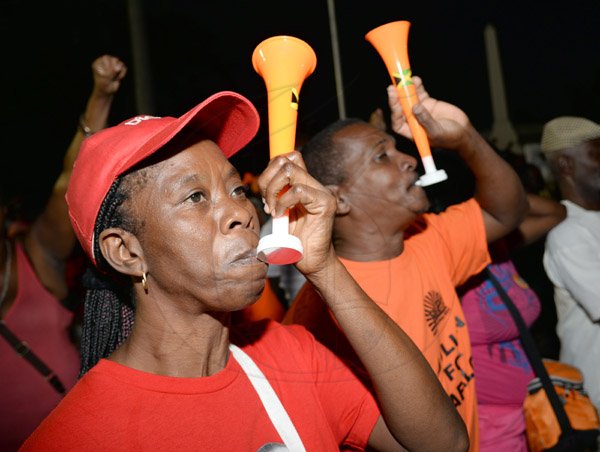 Jermaine Barnaby/Photographer
PNP supporters blow horns at the rally in St Thomas on Sunday November 29, 2015.