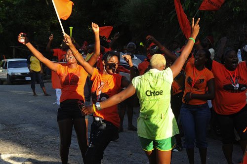 Ian Allen/Photographer
A lone JLP supporter among  PNP supporters while the PNP motorcade tour Gibbs Hill in St.Mary on wednesday.