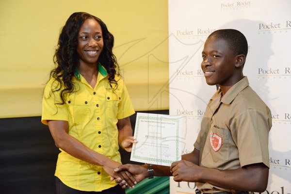 Rudolph Brown/Photographer
Double Olympic Sprint Champion Shelly-Ann Fraser Pryce, Chairperson of the Pocket Rocket Foundation presents scholarship to Brenton Bartley of Campion College at the Pocket Rocket Foundation scholarship to them at the presentation ceremony at Devon House on Tuesday, September 17, 2013
