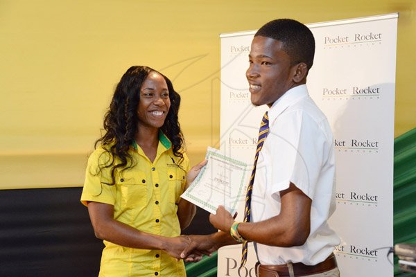 Rudolph Brown/Photographer
Double Olympic Sprint Champion Shelly-Ann Fraser Pryce, Chairperson of the Pocket Rocket Foundation presents scholarship to Shavor Scott of Ardenne High at the Pocket Rocket Foundation scholarship to them at the presentation ceremony at Devon House on Tuesday, September 17, 2013