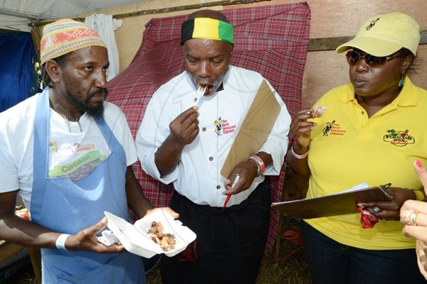 Rudolph Brown/Photographer
Malik Martin, (left)1st place winner of the Portland Jerk Festival give Chef Dennis McIntosh and Cordia Panton-Williams, of Best Dressed Chicken a taste of his chicken during the tasting of the judging at the Best Dressed Chicken Portland Jerk Festival at Folly Ruins in Portland on Sunday, July 7, 2013