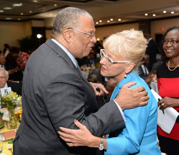 Jermaine Barnaby/Photographer
Dr. Peter Phillips (left) greeting Kelly Tomblin, President & CEO of Jamaica Public Service Company Ltd at the annual National Leadership Prayer Breakfast at the  Jamaica Pegasus Hotel in New Kingston on Thursday, January 21, 2016.