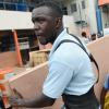 Rudolph Brown/PhotographerWorkmen carry ply board from the Super Valu Home Centre in Liguanea in preparation for Hurricane Matthew on Saturday, October 1, 2016