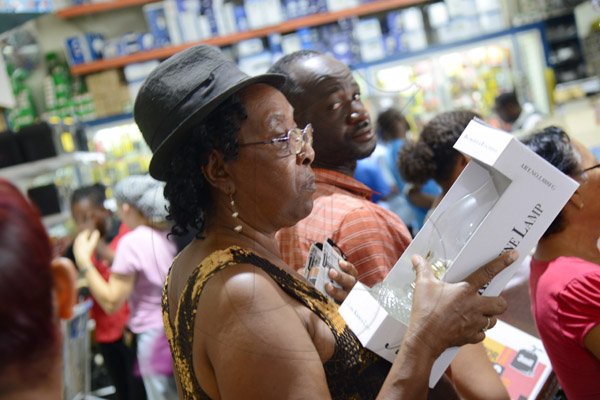 Rudolph Brown/PhotographerThis woman waiting in line with her lamp at the Super Valu Home Centre in Liguanea in preparation for Hurricane Matthew on Saturday, October 1, 2016