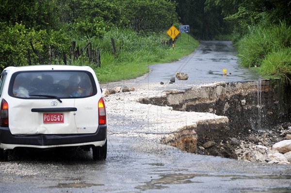 Ian Allen/Photographer
A section of the Dover Castle main road in St. Catherine that was washed away Monday night.