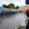 Ricardo Makyn/Staff Photographer
A Woman walks by  flooded street that runs of Burke road adjacent to the Bus Terminal in Spanish Town St Catherine due to the continued Rains of the last week on Sunday 5.6.2011