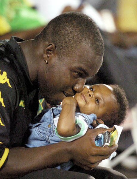 Ricardo Makyn/Staff Photographer.
National Footballer Devon Hodges playing with His new born Son Derron at the Jamaica vs Trinidad match  at the National Stadium on Sunday 10.10.2010.which Jamaica won by a score of 1-0 .