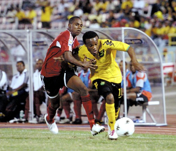 Ricardo Makyn/Staff Photographer
Jamaica's Dane Richards slips by Trinidad and Tobago's Jovian Jones during yesterday's friendly international at the National Stadium. Richards scored the lone goal, a penalty, to win the football match.