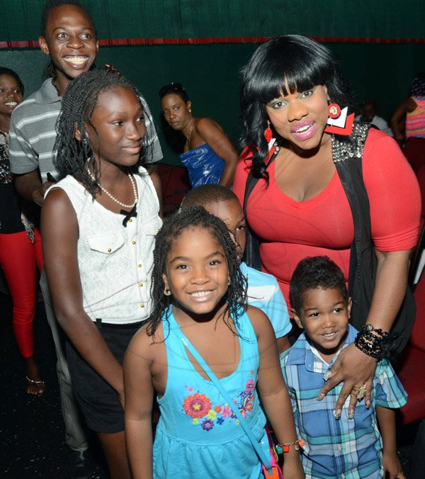 Rudolph Brown/Photographer
Ms Kitty pose with kids at the Reggae Jammin special viewing of the movie Disney Planes hosting they valued Customers Children at Palace Cineplex, Sovereign on Saturday, August 17, 2013