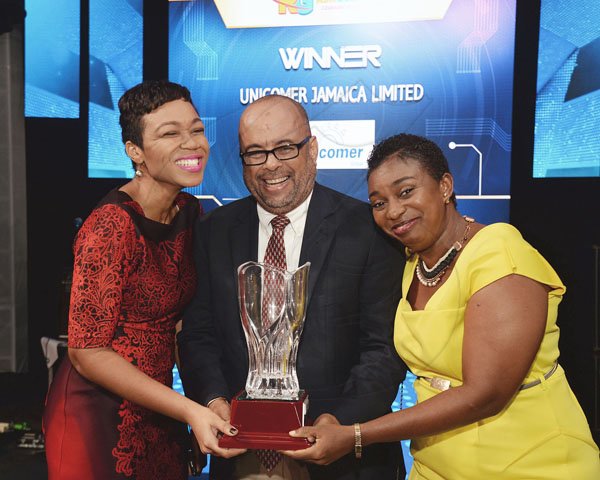 Jermaine Barnaby/ Freelance Photographer<\n>Katasha Thompson (left) and Jacqueline Edwards-Locke were delighted to collect from Michael Sharpe at the RJRGLEANER CLIENT APPRECIATION AWARDS at the Sunken Gardens at Hope Botanical Gardens on Thursday, June 22, 2017. *** Local Caption *** @Normal:Katasha Thompson (left) and Jacqueline Edwards-Locke of Unicomer Jamaica Ltd were delighted to collect the Top Spending Advertiser Award with The Gleaner from Michael Sharpe.