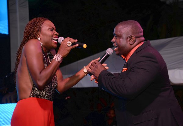 Jermaine Barnaby/ Freelance PhotographerMc's Jenny Jenny (left) and Burger Man having a sing off during the RJRGLEANER CLIENT APPRECIATION AWARDS at the Sunken Gardens at Hope Botanical Gardens on Thursday, June 22, 2017.