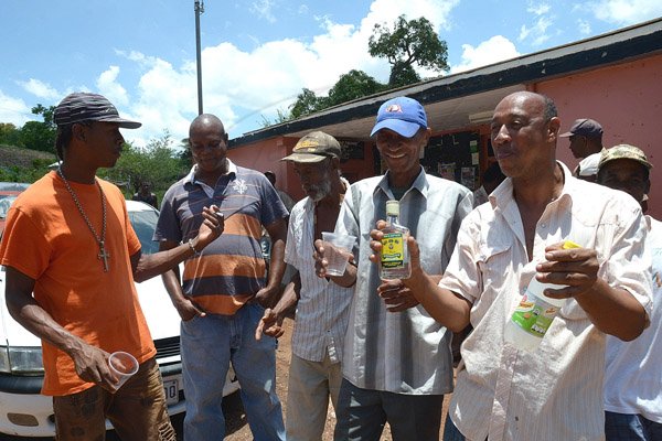 Ian Allen/Staff Photographer
Men from Rose Hall Community Arming themselves with White Rum to fight a Ghost that has been terrorizing Residents of a House in Rose Hall District in St.Elizabeth for weeks.