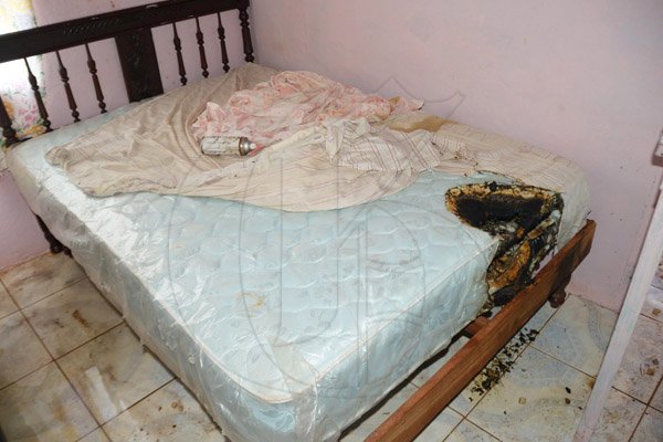 Ian Allen/Staff Photographer
A burnt bed the family says caught fire last night

Furnitures that was damaged by Duppy in a house in Rose Hall District, St.Elizabeth.